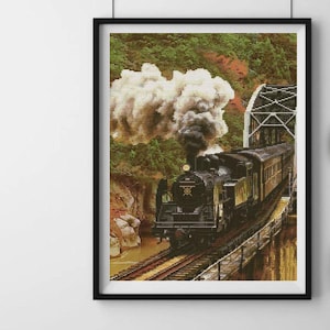 May include: A black steam locomotive train with smoke billowing from the engine, travelling through a lush green forest. The train is crossing a bridge over a river.