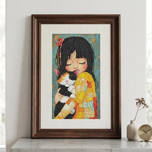 May include: A framed wall art print featuring a stylized illustration of a person with long black hair and a red hair accessory, embracing a calico cat. The background has a textured blue and gold pattern, and the person wears a yellow shirt.