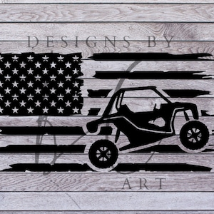 May include: Black and white silhouette of an off-road vehicle jumping over a distressed American flag design. The text "DESIGNS BY ART" is below the image.