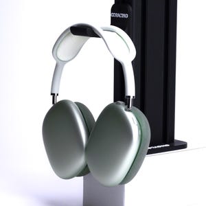 May include: A pair of green and white over-ear headphones with a white headband and a black stand.