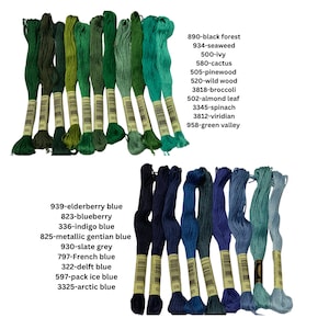 May include: A collection of 18 spools of DMC embroidery floss in shades of green, blue, and teal. The floss is arranged in two rows, with the numbers and color names printed on the spools.