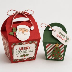 May include: A large red gift box with a Santa Claus cutout, a Merry Christmas label, and red and white twine, alongside a smaller green gift box featuring a Christmas tree cutout, a Happy Holidays tag, and red and white twine.