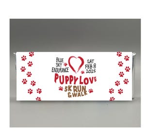 May include: White and red banner with paw prints and a red heart. The text reads "Blue Sky Endurance", "Sat Feb 8 2025", "Puppy Love", "5K Run & Walk".