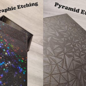 May include: Two boxes with different surface designs. One box has a black surface with holographic stars and the text "Holographic Etching". The other box has a gray pyramid pattern and the text "Pyramid Etching".