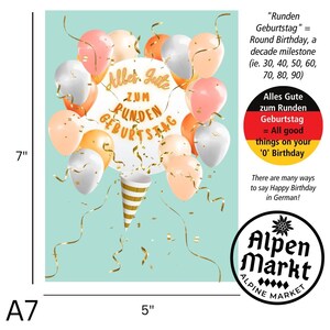 May include: A card featuring a colourful balloon design with the text "Alles Gute zum Runden Geburtstag" in gold lettering. The card also includes a German flag with the text "Alles Gute zum Runden Geburtstag = All good things on your '0' Birthday". The card is from Alpen Markt.