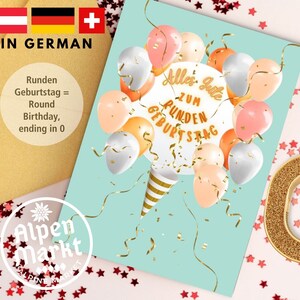 May include: A birthday card with a light blue background featuring a white circle with the text "Alles Gute zum Runden Geburtstag" in gold lettering. The circle is surrounded by colourful balloons and confetti. The card is decorated with a gold star pattern.