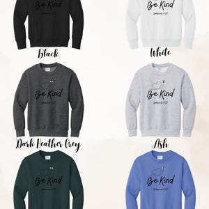 May include: Sweatshirts in black, white, dark heather grey, ash, dark heather grey, and Carolina blue. Each sweatshirt features the text "Be Kind" with a heart and bee design, and the Bible verse Ephesians 4:32.