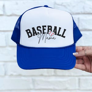 May include: A blue and white trucker hat with the text "Baseball Mama" and a baseball in a heart shape.
