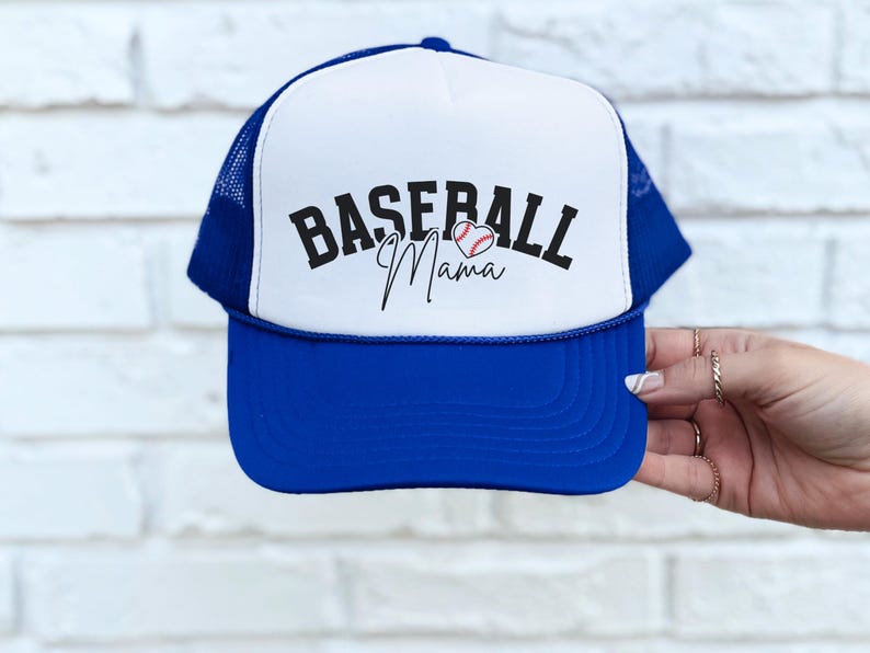 May include: A blue and white trucker hat with the text "Baseball Mama" and a baseball in a heart shape.