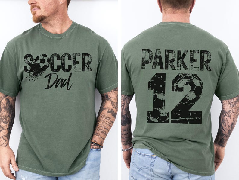 Custom Soccer Shirt for Dad. The soccer tshirt says Soccer Dad on the front in a black varsity collegiate style font. The back is personalized with the players name and number. The number is a collegiate font with a soccer ball pattern. comfort colors tee, short sleeves, crewneck soccer dad tshirt
