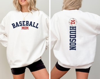 May include: White sweatshirt with the text "Baseball Mom" on the front and a baseball with the number 25 and the text "HUDSON" on the back.