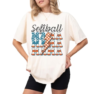 Retro patriotic softball mama shirt for 4th of July and Memorial day. The t shirt says, softball in black distressed script and the word mama repeated 3 times in a red white and blue USA flag font. A checkered lightning bolt down the middle
