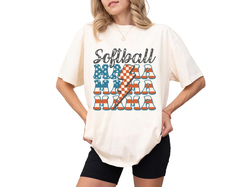 Retro patriotic softball mama shirt for 4th of July and Memorial day. The t shirt says, softball in black distressed script and the word mama repeated 3 times in a red white and blue USA flag font. A checkered lightning bolt down the middle