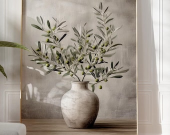 May include: A framed artwork featuring olive branches in a white vase, set against a neutral backdrop. A potted plant and a footstool are in the foreground. Two terracotta vases and a small pot are on the right.