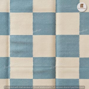 May include: A textile rug featuring a repeating checkerboard pattern in alternating squares of dusty blue and off-white. The fabric has a visible woven texture with a soft, slightly fuzzy surface appearance throughout the entire square grid design.