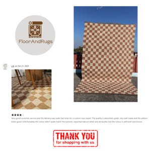 May include: A rectangular area rug featuring a repeating checkered pattern in alternating shades of brown and beige. The rug has a textured surface and a fringed edge along the top and bottom, displayed vertically against a clear blue sky.