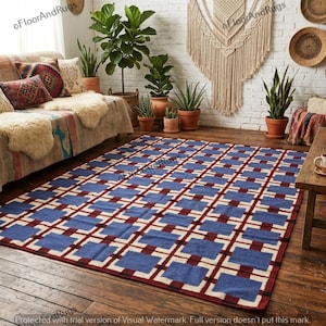 May include: A rectangular area rug featuring a repeating grid pattern of blue squares separated by dark red and cream-colored lines. The rug is laid flat on a dark wooden floor, showcasing a geometric design that covers the entire surface area.