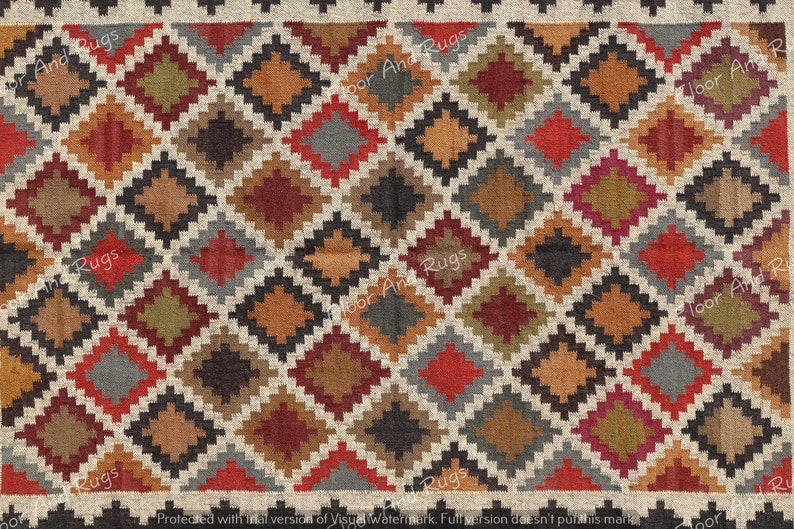 May include: A woven rug featuring a repeating geometric diamond pattern in a palette of red, orange, olive green, charcoal gray, and brown, outlined in cream. The text Floor And Rugs is visible in a repeating watermark across the surface.