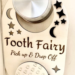May include: Wooden tooth fairy door hanger with a crescent moon, stars, and the text "Tooth Fairy Pick up & Drop Off". The hanger has a small circle with multiple tooth shapes.
