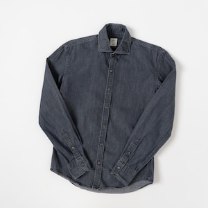May include: A long-sleeve button-down shirt in a dark charcoal gray denim fabric. The shirt features a standard collar, a front button placket with matching dark buttons, and buttoned cuffs on the sleeves. A small white label is visible at the neck.