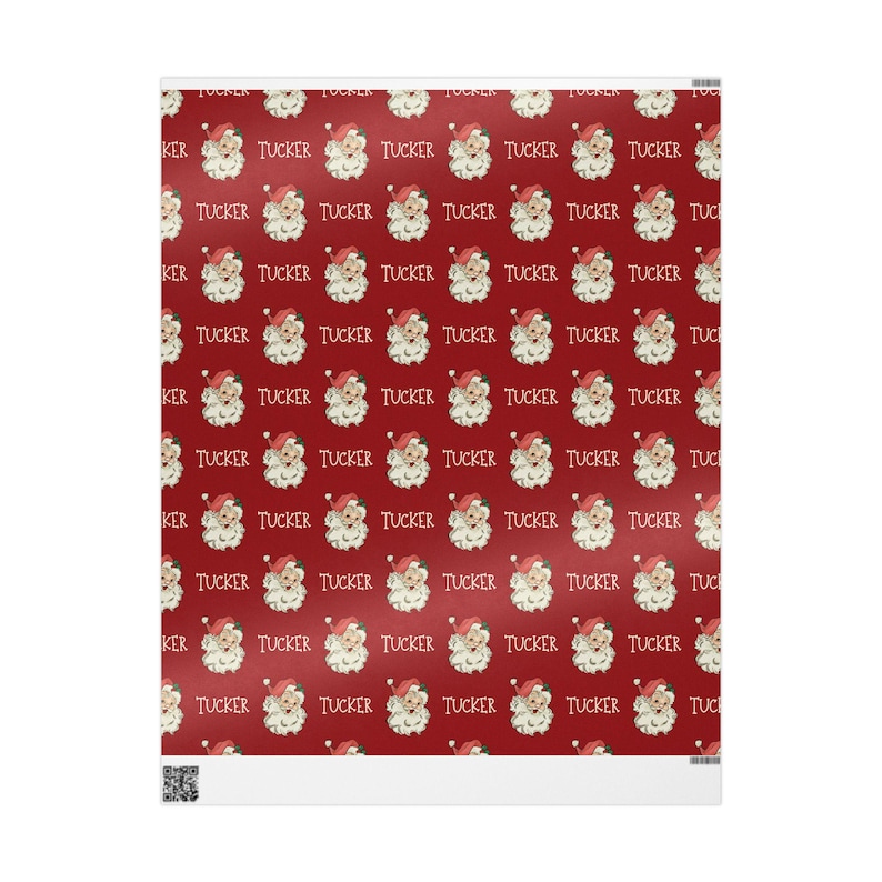May include: Red wrapping paper with a repeating pattern of Santa Claus faces and the name "Tucker" written in white.