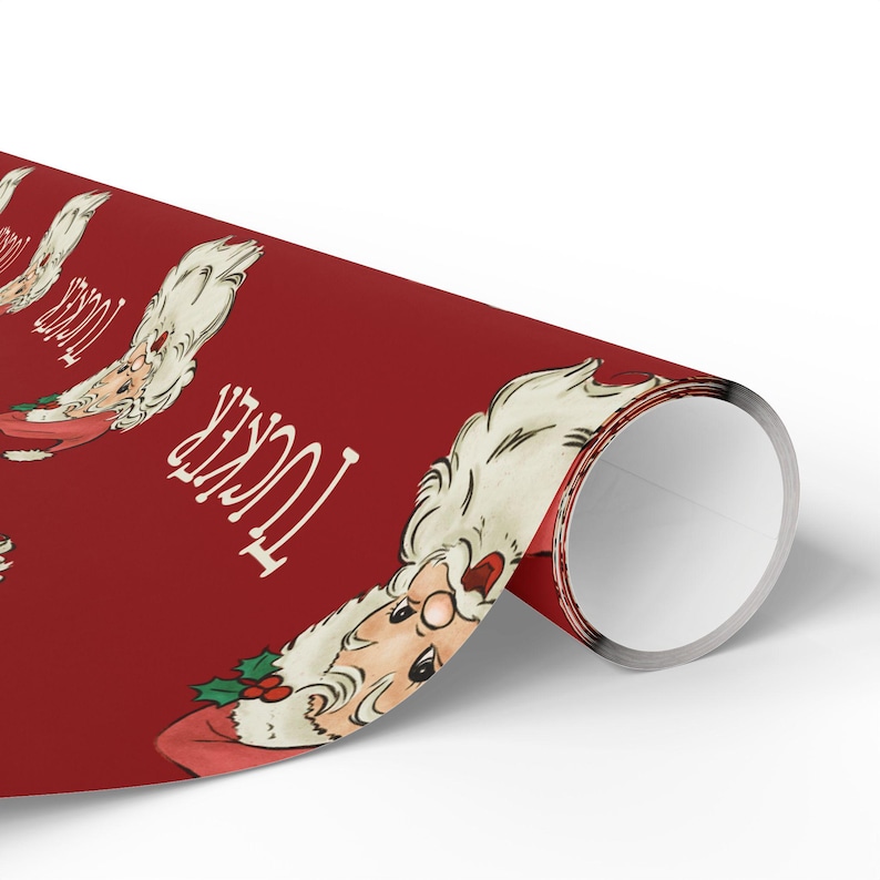 May include: Red wrapping paper with a repeating pattern of a cartoon Santa Claus with white hair and beard. The text "Tucker" is printed on the paper.