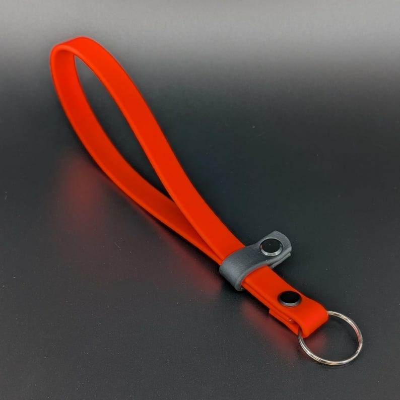 orange and black biothane adjustable wrist strap for e-collar remote transmitter for dog training