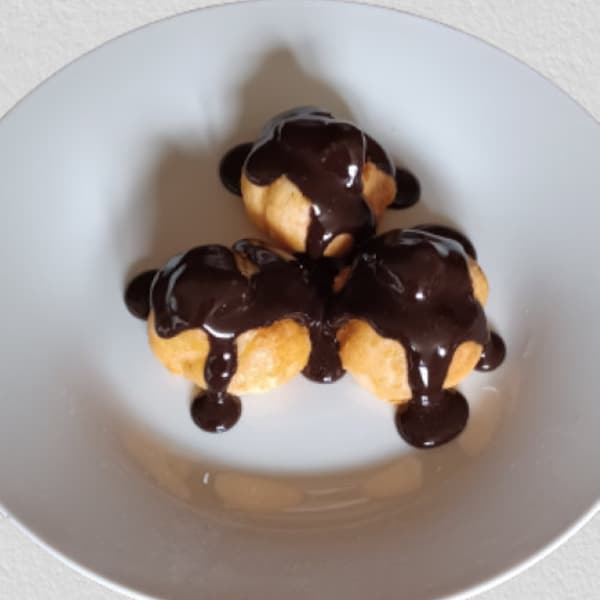 Choux à la crème avec réplique de faux aliments au fudge chaud