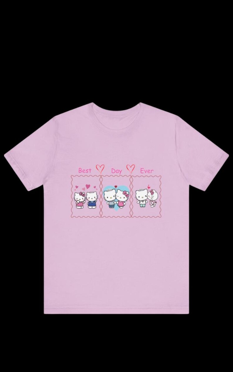 May include: A light pink t-shirt featuring three panels with cartoon characters and the text "Best Day Ever." Each panel depicts a couple with hearts. The shirt is a crew neck style.
