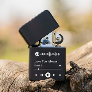 May include: Black lighter with a personalized message that reads "Love You Always" with a music note icon, a barcode, and the name "Frank J".