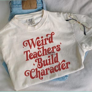 May include: A white t-shirt with the text "Weird Teachers Build Character" in red letters. The text is in a retro font style.