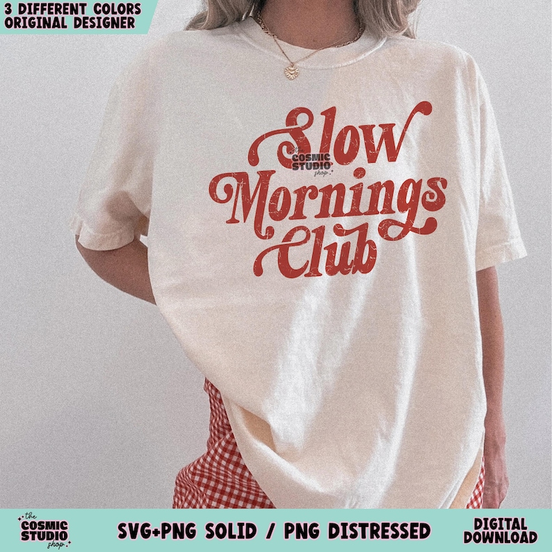 May include: A white t-shirt with the text "Slow Mornings Club" in red lettering. The text is in a retro font style.