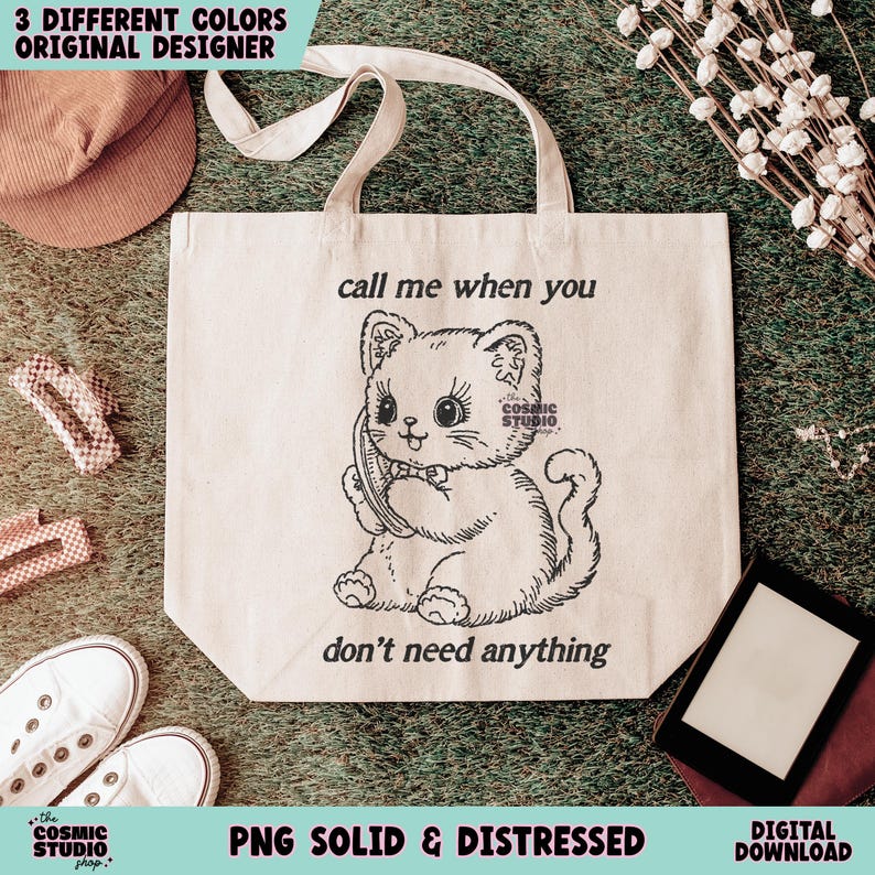 May include: Cream-colored tote bag with a black and white illustration of a cat holding a phone. The text "call me when you don't need anything" is above and below the cat. The words "3 DIFFERENT COLORS ORIGINAL DESIGNER" are at the top.
