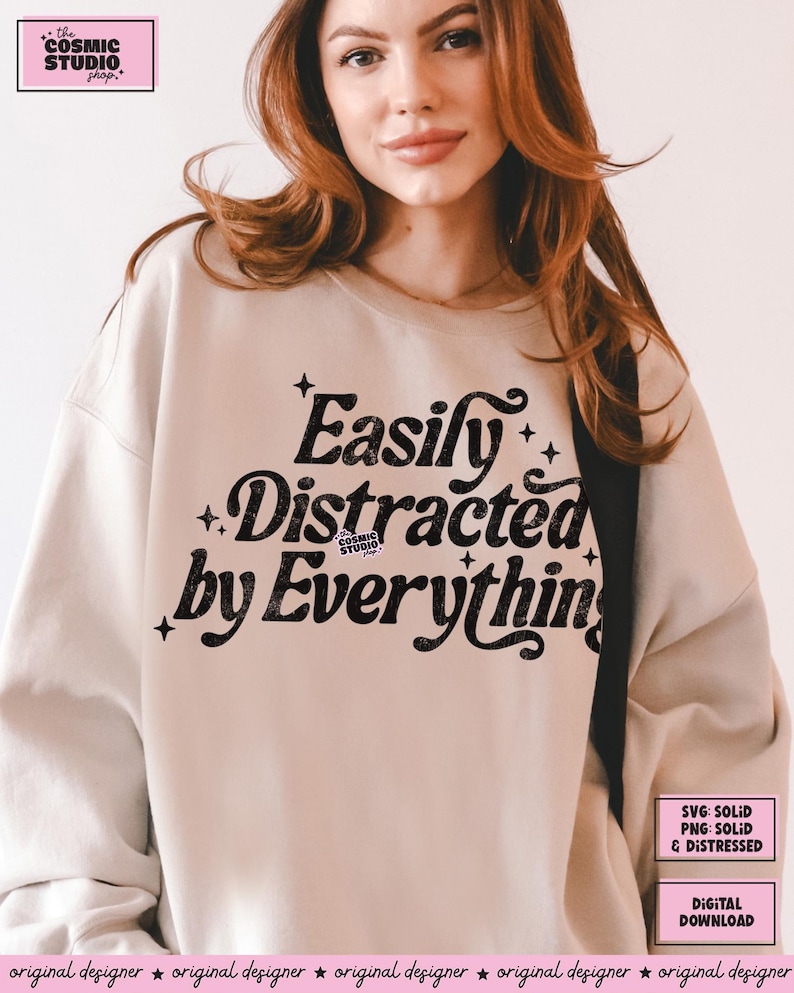 May include: A beige sweatshirt featuring the phrase "Easily Distracted by Everything" in black, stylized lettering. The design incorporates star motifs. Additional text indicates the design is available as SVG and PNG files, and as a digital download.