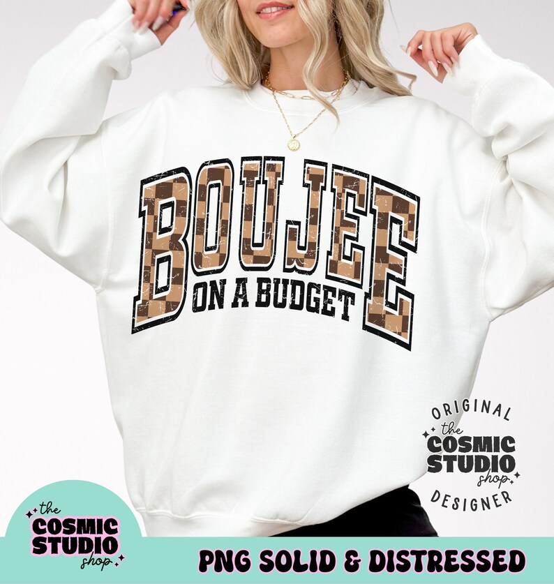 May include: White sweatshirt with a brown and black checkered graphic that says "Boujee on a Budget". The graphic has a distressed look. The sweatshirt is a mock-up and is not for sale.