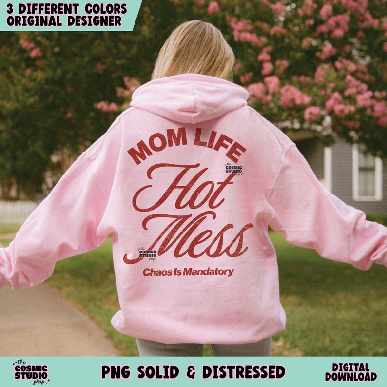 May include: A light pink hoodie with the words "MOM LIFE Hot Mess" in a distressed red font. The phrase "Chaos Is Mandatory" is below. The hoodie has a hood and long sleeves. The text "3 DIFFERENT COLORS ORIGINAL DESIGNER" is at the top.