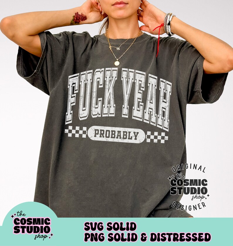 May include: A grey t-shirt with a white graphic that says "F**K YEAH" with "PROBABLY" underneath. The graphic is in a vintage style with a checkered border. The t-shirt is distressed and has a faded look.