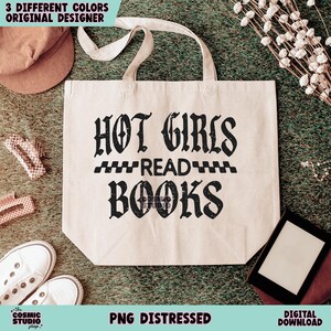 May include: A white tote bag with black text that reads "HOT GIRLS READ BOOKS" in a distressed font. The text is in a gothic style font.