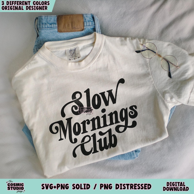 May include: A white t-shirt with black text that reads "Slow Mornings Club".