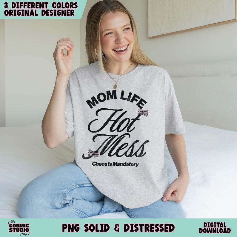 May include: A light gray t-shirt with the words "MOM LIFE Hot Mess" in black script. The phrase "Chaos Is Mandatory" is below. The shirt is part of a digital download and is available in three different colors.