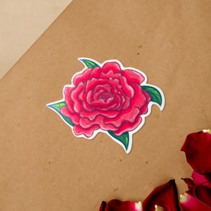 May include: A red rose with green leaves, drawn in a cartoon style. The rose is the main focus of the image, and it is set against a brown background.