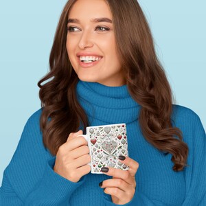 A woman wrapped in a blue sweater, smiling as she enjoys a beverage from the Pet Lover mug, the intricate pet-themed pattern wrapping the exterior.