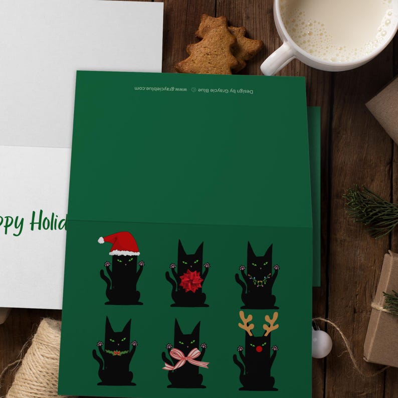 A green card featuring six black cat illustrations. Each cat is in a different holiday outfit. One cat wears a Santa hat, another has a red bow, and a third has a string of lights. The remaining cats are decorated with a green garland, a pink bow, and reindeer antlers.