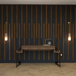 May include: A dark wood desk with a black metal frame sits in front of a wall with dark wood panels. Two gold wall sconces with glass shades are on either side of the desk.