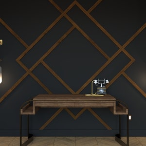 May include: A dark wood desk with a black metal frame sits in front of a dark blue wall with a geometric pattern of brown wood strips. A vintage rotary phone sits on the desk with a yellow cord.
