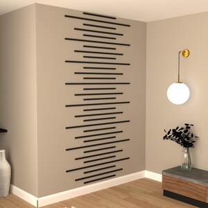 May include: A modern living room interior with a wall accent featuring a geometric pattern of black horizontal lines. A round, white globe light fixture hangs from the ceiling. A small, dark brown table with a vase of dried flowers sits in the corner.