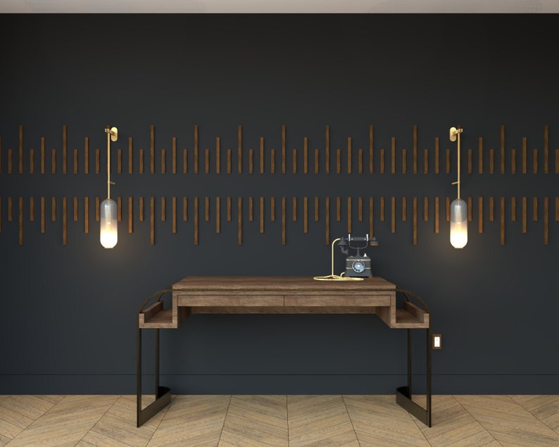 May include: A dark wood desk with a black metal frame and two drawers. The desk is set against a black wall with a wooden accent wall behind it. Two gold wall sconces with glass shades are on either side of the desk. A vintage black rotary phone sits on the desk.