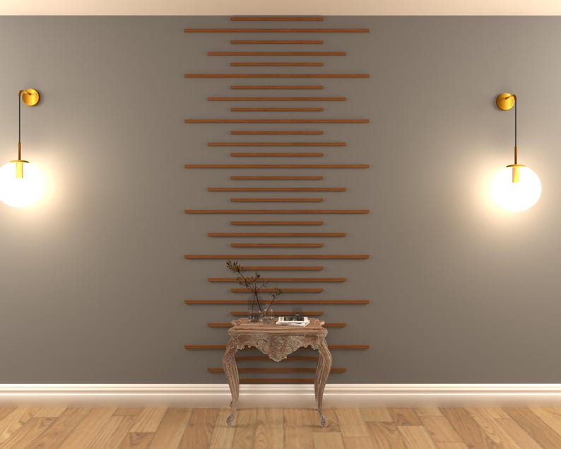 May include: A wooden side table with a carved design and a distressed finish. The table has a single shelf and is decorated with a small plant and a book. The table is in front of a wall with a decorative wood slat wall treatment and two gold wall sconces with round glass shades.
