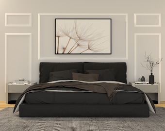May include: A black bed with a white and gray patterned rug. The bed has a black headboard and a brown blanket. There is a framed print of a dandelion above the bed.