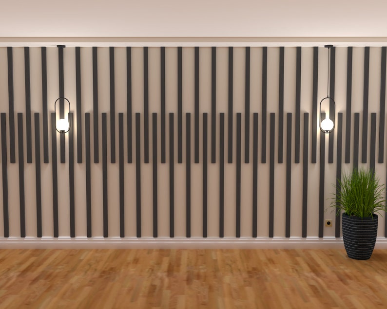 May include: A room with a wood floor and a wall with a geometric pattern of black and white vertical lines. Two black pendant lights with clear glass globes hang from the ceiling. A potted plant with green leaves is on the right side of the image.